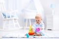 Baby playing with toy pyramid. Kids play Royalty Free Stock Photo