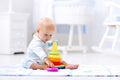 Baby playing with toy pyramid. Kids play Royalty Free Stock Photo