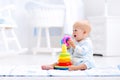 Baby playing with toy pyramid. Kids play Royalty Free Stock Photo