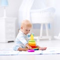 Baby playing with toy pyramid. Kids play Royalty Free Stock Photo
