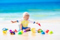 Baby playing on tropical beach digging in sand Royalty Free Stock Photo