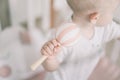 Baby playing with wooden toy. Kids hands holding a wooden baby rattle. Eco friendly non plastic toys concept. space for text. Royalty Free Stock Photo