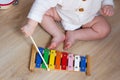 Baby playing xylophone, tambourine. Kids musical instrument toy. Little child musician Royalty Free Stock Photo