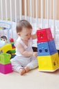 Baby plays nesting blocks at home Royalty Free Stock Photo