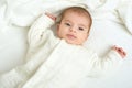 Baby portait lie on white towel in bed, yellow toned