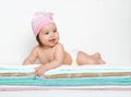 Baby portrait in diaper on towel at studio, white background Royalty Free Stock Photo