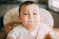 Baby portrait of a dirty stained cream meringue or cream