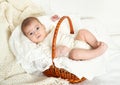 Baby portrait lie on white towel in bed, yellow toned Royalty Free Stock Photo