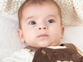 Baby portrait lie on white towel in bed, yellow toned Royalty Free Stock Photo