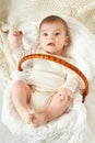 Baby portrait lie on white towel in bed, yellow toned Royalty Free Stock Photo