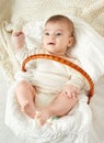 Baby portrait lie on white towel in bed, yellow toned Royalty Free Stock Photo