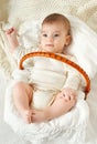 Baby portrait lie on white towel in bed, yellow toned Royalty Free Stock Photo