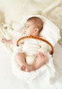 Baby portrait lie on white towel in bed, yellow toned Royalty Free Stock Photo