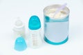 Baby powder milk formula in a can next to baby bottles Royalty Free Stock Photo