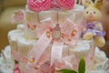 Used for decoration when the child leaves the hospital . Pink children`s shoes . Rabbit toys . ribbon . Baby pram made of diapers