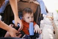 Baby, pram and outdoor for park, hands and mother for walk and family time with child. Kid, stroller and mom in backyard Royalty Free Stock Photo