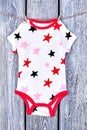 Baby printed bodysuit on clothesline. Royalty Free Stock Photo