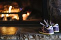 Purple sneakers heating on a fire place