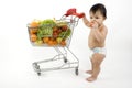 Baby pushes a shopping cart Royalty Free Stock Photo