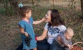 The baby puts her mother in her mouth a big and sweet grape Royalty Free Stock Photo