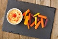 Baby rainbow carrots with hummus on slate server