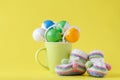 Baby rattle in cup on yellow background Royalty Free Stock Photo