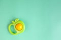 Baby rattle on green background Royalty Free Stock Photo