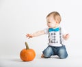 Baby Reaches for Pumpkin Interested