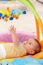 Baby reaching for toy