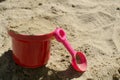 Baby red bucket and pink scoop in the sandbox Royalty Free Stock Photo
