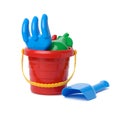 Baby red plastic bucket, shovel and rake on white background, set Royalty Free Stock Photo