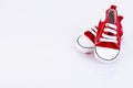 Baby red sneakers isolated on white background. Children's shoes store. Copy space Royalty Free Stock Photo