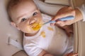 Baby refusing food while mother feeding him Royalty Free Stock Photo