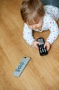 Baby with remote controls Royalty Free Stock Photo