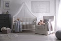 Baby room interior with crib and armchair Royalty Free Stock Photo