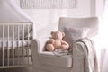 Baby room interior with crib and armchair Royalty Free Stock Photo