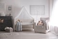 Baby room interior with crib and armchair Royalty Free Stock Photo