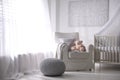 Baby room interior with crib and armchair Royalty Free Stock Photo