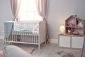 Baby room interior with comfortable crib Royalty Free Stock Photo