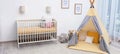 Baby room interior with comfortable crib and play tent. Banner Royalty Free Stock Photo