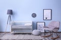 Baby room interior with crib and rocking chair wall