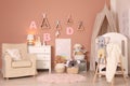 Baby room interior with stylish furniture and comfortable crib Royalty Free Stock Photo