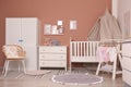 Baby room interior with stylish furniture and crib Royalty Free Stock Photo