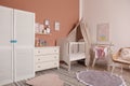 Baby room interior with stylish furniture and crib Royalty Free Stock Photo