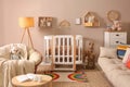 Baby room interior with stylish furniture and comfortable crib Royalty Free Stock Photo