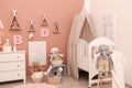 Baby room interior with furniture and comfortable crib Royalty Free Stock Photo