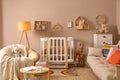 Baby room interior with stylish furniture and crib Royalty Free Stock Photo