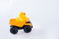 Baby`s duck on yellow car isolated on white background. copy space. concept of childhood Royalty Free Stock Photo