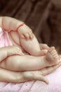Baby s feet in mom s palms Royalty Free Stock Photo