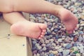 Baby`s feet of a small child close-up on the pebble beach. Vacation on the Mediterranean sea Royalty Free Stock Photo